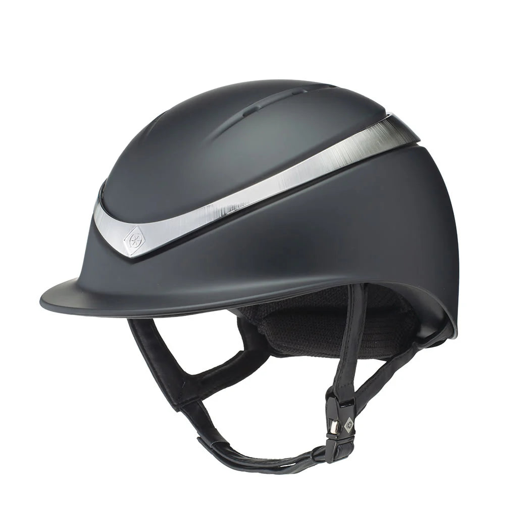 Black riding helmet with a silver stripe on a white background. Charles Owen England helmets available with Nice Equestrian Wukair Doha Qatar. One of the highest safeties ranked helmets in the world.
