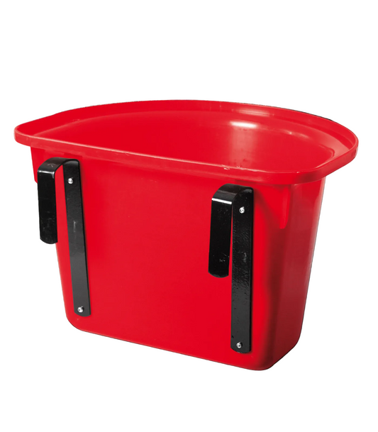 Red plastic horse feeder hanging over a door bracket.