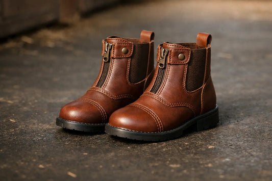 Children's brown leather jodhpur riding boots on a clean stable floor in Qatar — buying guide for parents