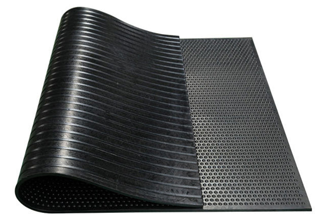 A black rubber stable mat with a textured surface designed for use in horse stables. Made in China. Available with Nice equestrian Wukair Doha Qatar.