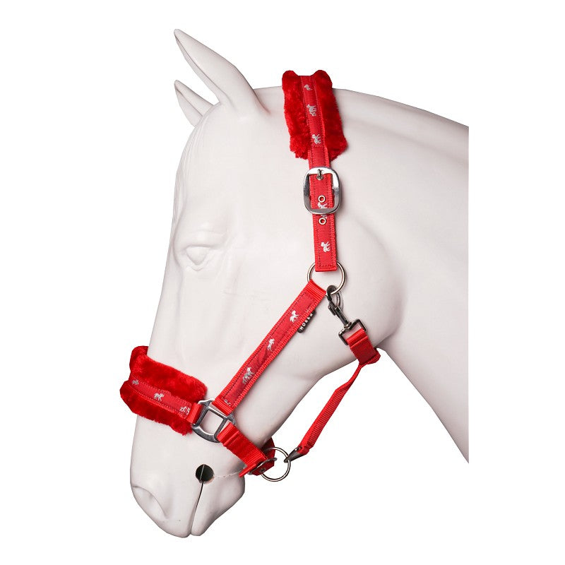 A plush red horse halter with soft fur lining on the noseband and headpiece, displayed on a white horse mannequin. Horka. Available with Nice Equestrian Wukair Doha Qatar