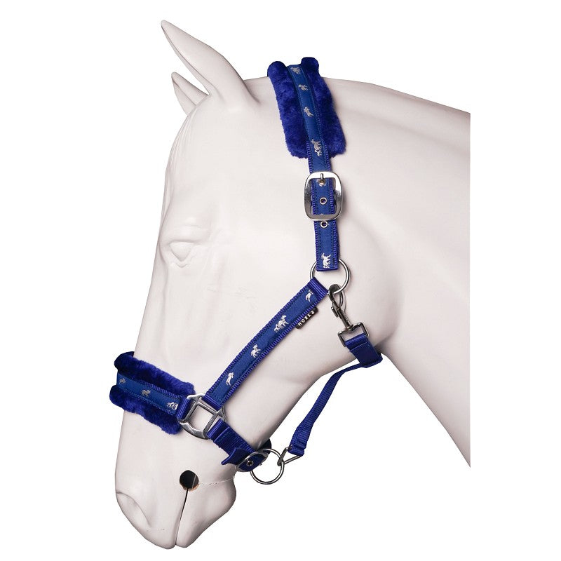 A blue halter with soft fur lining on a white horse mannequin.
A plush blue horse halter with soft fur lining on the noseband and headpiece, displayed on a white horse mannequin. Horka. Available with Nice Equestrian Wukair Doha Qatar