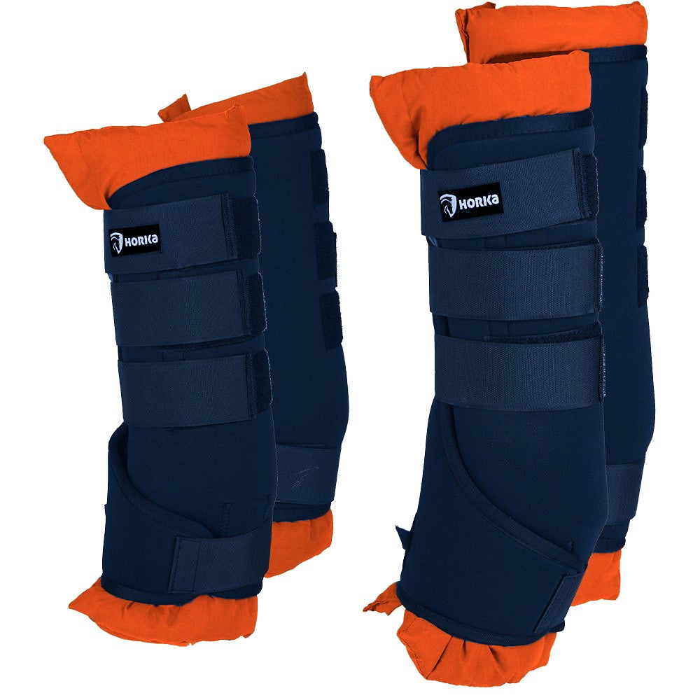 A pair of orange horse boots with straps and padding, designed for travel and stable use. Horka. Available with Nice Equestrian Wukair Doha Qatar
