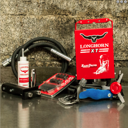 A set of grooming tools including a hair clipper, a sure grip handpiece, and various accessories, primarily in red and black colors, displayed against a brick wall background.
Long Horn. Model XT. Made in UK. Available with Nice Equestrian Wukair Doha Qatar.