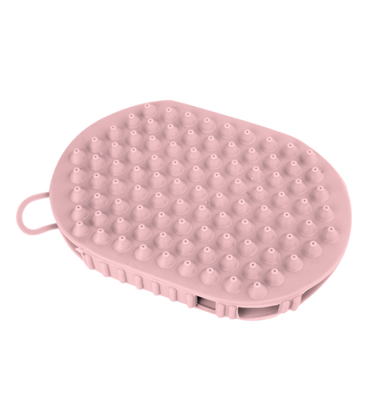 A pink grooming glove with rubber nobs on one side and massage balls on the other, designed for horse care.