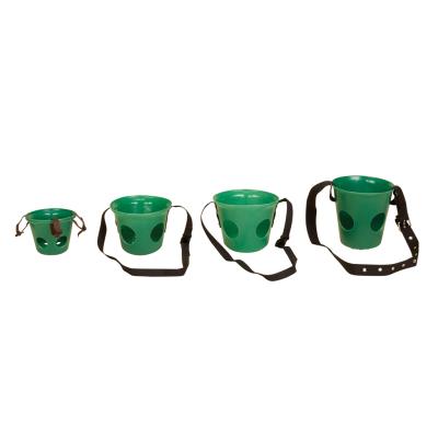 A set of three green horse muzzles with straps, positioned side by side against a white background. Abbey England Stubbs muzzle available with Nice Equestrian Wukair Doha Qatar.