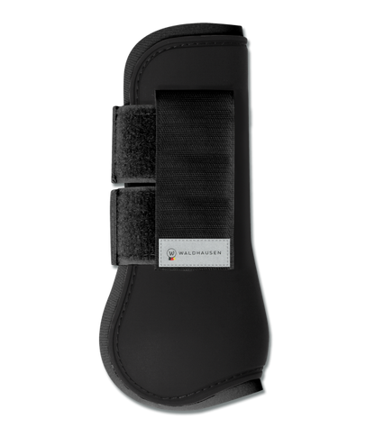 A black horse tendon boot with black straps and a hard-shell exterior, designed for leg protection.